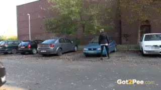 Squatting between parked cars piss